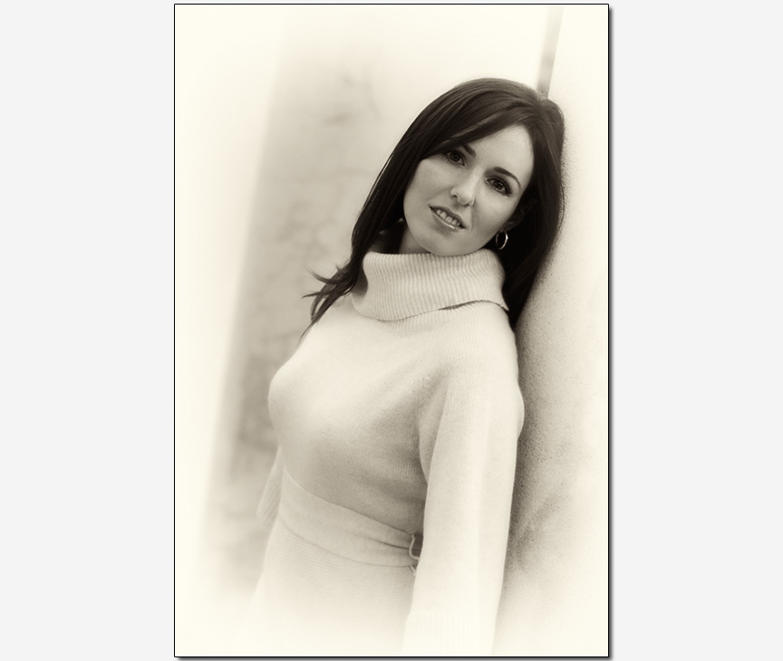 Cuban-American bride-to-be leaning on pillar