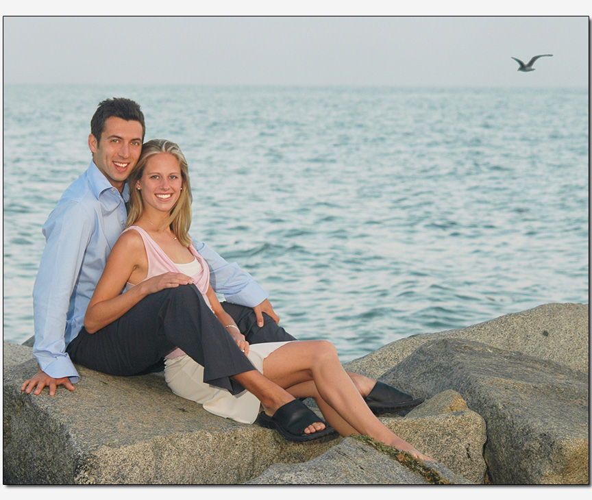 relaxed couple casual pose rocky beach
